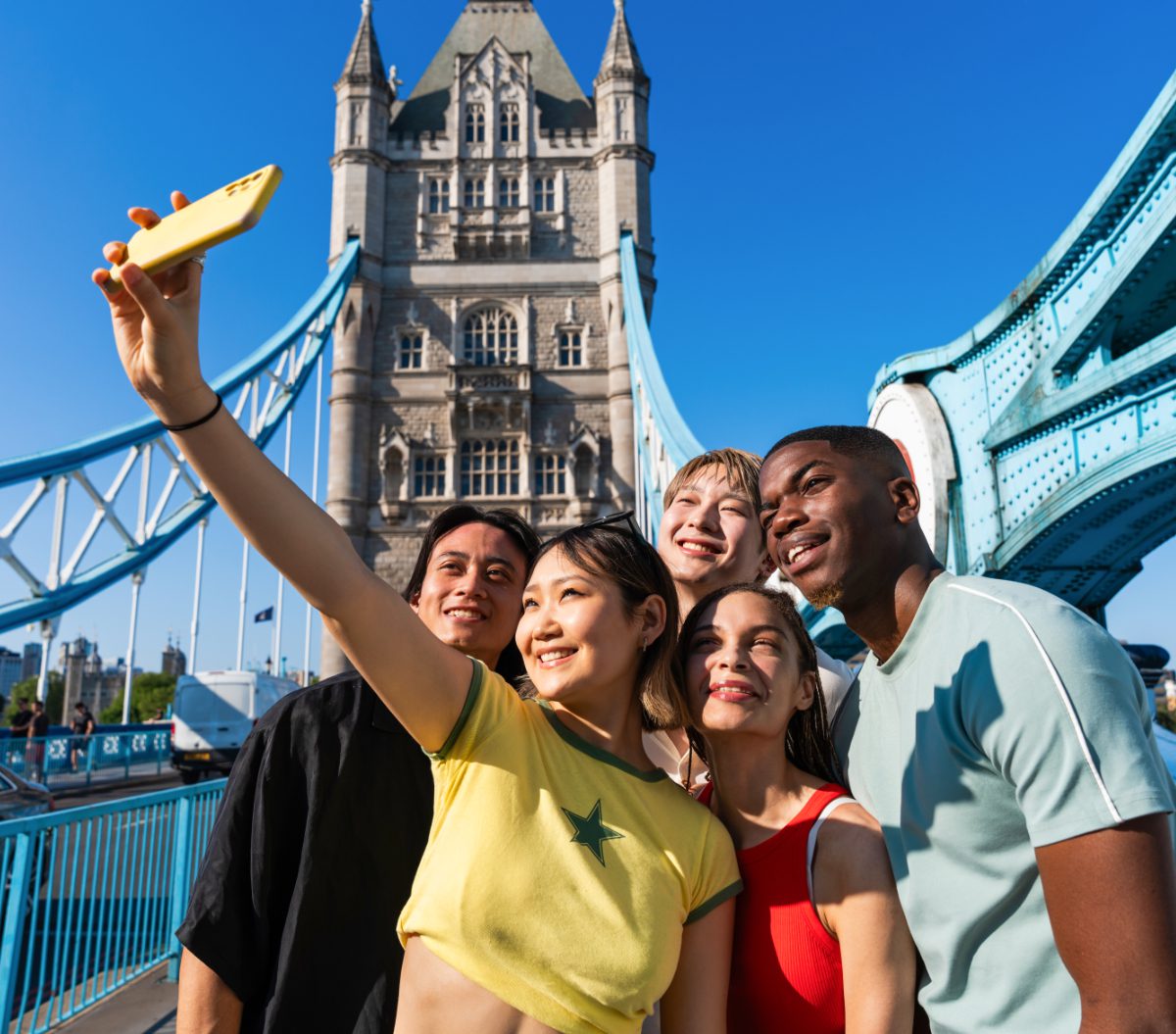 Multiracial group of happy young students bonding in London